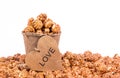 Caramel popcorn in a paper bucket. A pile of caramel creamy popcorn on a white background. Royalty Free Stock Photo