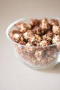 Caramel pop corn. Glass plate. Light background