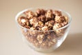 Caramel pop corn. Glass plate. Light background