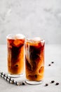 Caramel vanilla iced coffee with ice cubes in tall glasses Royalty Free Stock Photo