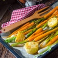 Caramelised carrots, spring onions and baked potatoes Royalty Free Stock Photo