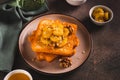 Caramelized bananas with nuts on fried bread on a dessert plate on the table Royalty Free Stock Photo