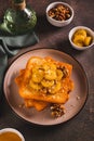 Caramelized bananas with nuts on fried bread on a dessert plate on the table vertical view Royalty Free Stock Photo