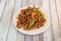 Caramelized beef strips with strips of red and green peppers, carrots and onions sauteed