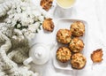 Caramelized cinnamon apples muffins, green tea, bouquet of chrysanthemums, knitted plaid on a light background, top view. Cozy Royalty Free Stock Photo