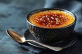 Caramelized custard dessert in rustic bowl with spoon Royalty Free Stock Photo