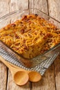 Caramelized Noodle and Pepper Yerushalmi Kugel with raisins close-up in a glass bowl. Vertical