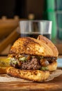 Caramelized onion burger with avocado sauce cut in half, with sauces and french fries on the side Royalty Free Stock Photo