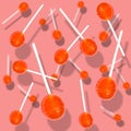 Caramels on a stick falling on different planes on a pink background