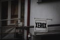 CARANSEBES, ROMANIA - SEPTEMBER 16, 2022: Old and crumbling Xerox logo on a photocopy and printing house. Xerox is a multinational