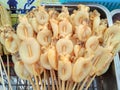 Carapace squid are dipped in a large amount of yellow marinade for grilled seafood.