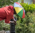 Caravaca de la Cruz, Spain, May 2, 2019: Black male drinking water on a font Royalty Free Stock Photo