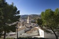 Caravaca, Spain - November 17, 2017: panorama of the city of Caravaca de la Cruz and conifers in the foreground, a place