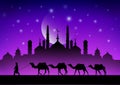 caravan of camels in the desert near the mosque under the moon Royalty Free Stock Photo
