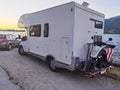 Caravan car beside the lake with motorbike in back side Royalty Free Stock Photo