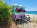 caravan car by the sea bikes surf surfing beach umbrellas trees in summer Royalty Free Stock Photo