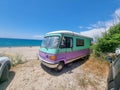 caravan car by the sea bikes surf surfing beach umbrellas trees in summer Royalty Free Stock Photo