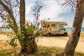 Caravan car by the sea in summer beach trees blue sky Royalty Free Stock Photo