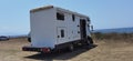 Caravan car by the sea in summer beach trees blue sky Royalty Free Stock Photo