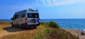 Caravan car by the sea in summer beach trees blue sky Royalty Free Stock Photo