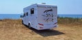 Caravan car by the sea in summer beach trees blue sky Royalty Free Stock Photo