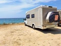 Caravan car by the sea in summer beach trees blue sky Royalty Free Stock Photo