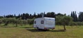 Caravan car by the sea in summer beach trees blue sky Royalty Free Stock Photo