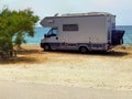 Caravan car by the sea in summer beach trees blue sky Royalty Free Stock Photo