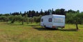 Caravan car by the sea in summer beach trees blue sky Royalty Free Stock Photo