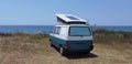 Caravan car solar panels electricity  by the sea in summer beach trees blue sky  travel Royalty Free Stock Photo