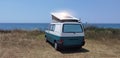 Caravan car solar panels electricity  by the sea in summer beach trees blue sky  travel Royalty Free Stock Photo