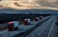 Caravan or convoy of lorry trucks on country highway
