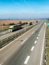 Caravan or convoy of Yellow lorry trucks on country highway Royalty Free Stock Photo
