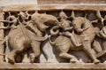Caravan of elephants on wall of temple in India
