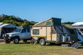 Caravan with four wheel drive vehicle in a holiday park.