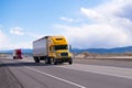 Caravan modern semi trucks on straight highway on plateau