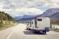 Caravan or motor home trailer on a mountain road Royalty Free Stock Photo