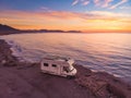 Caravan on sea coast at sunrise. Aerial view