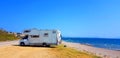 Caravan trailer car by the sea in summer holidays Royalty Free Stock Photo