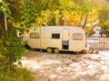 Caravan trailer old  autumn trees Royalty Free Stock Photo