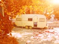 Caravan trailer old  autumn trees sun Royalty Free Stock Photo