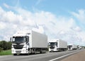Caravan of white trucks on highway Royalty Free Stock Photo