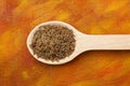 Caraway fruits on wooden spoon