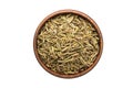 Caraway seed spice in wooden bowl, isolated on white background. Seasoning top view