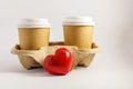 carboard coffee cups with a red heart