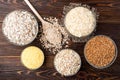 Carbohydrates. Various grain flakes in bowls on wooden. Oat, corn, rice, buckwheat, rye and wheat flakes. Royalty Free Stock Photo