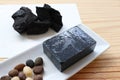 Carbon and bamboo charcoal soap on wood background