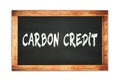 CARBON CREDIT text written on wooden frame school blackboard