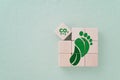 Carbon ecological footprint symbol with green leaves, reduce co2 on wooden cube blocks. eco friendly, zero emission concept. Royalty Free Stock Photo