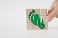 Carbon ecological footprint symbol with green leaves, reduce co2 on wooden cube blocks. eco friendly, zero emission concept. Royalty Free Stock Photo